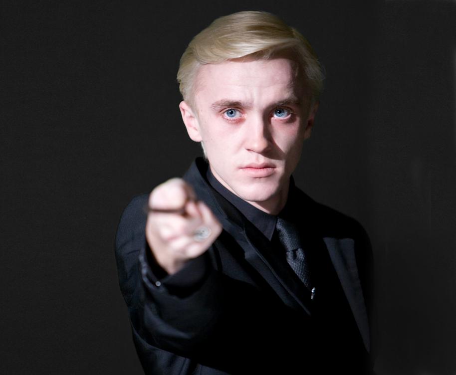 An emotional Draco points his wand