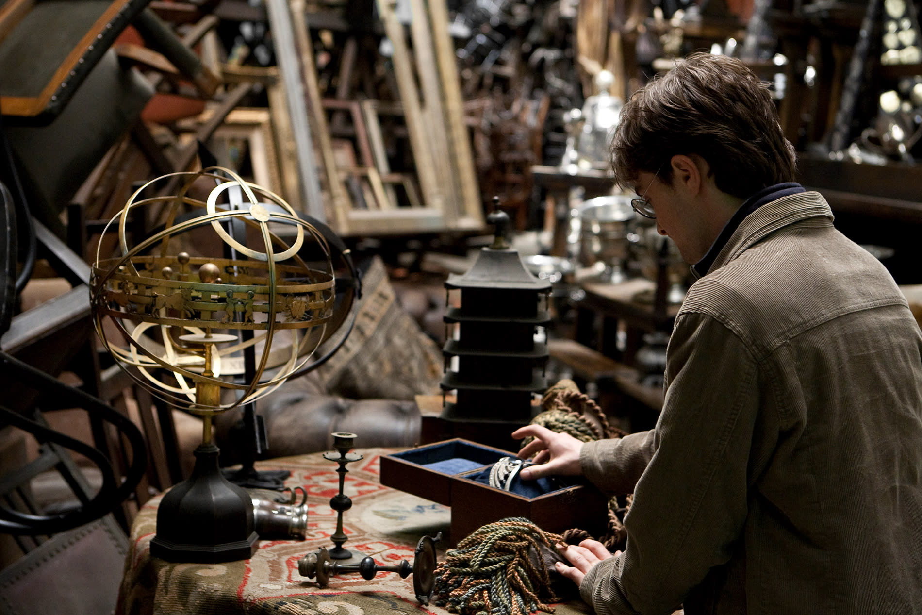 Harry Potter sits down with Ravenclaw's diadem, a blue tiara, alongside various other trinkets.