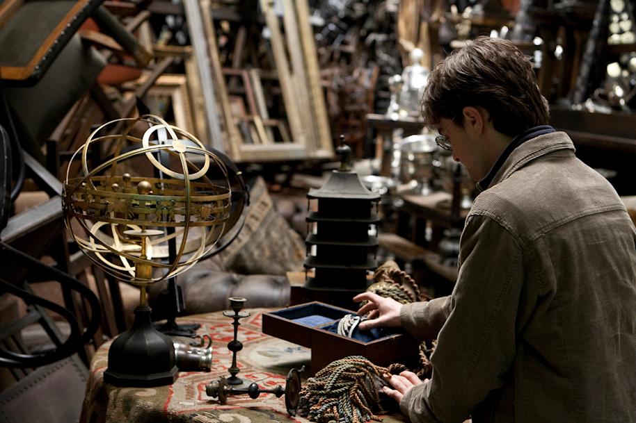 Harry Potter sits down with Ravenclaw's diadem, a blue tiara, alongside various other trinkets.